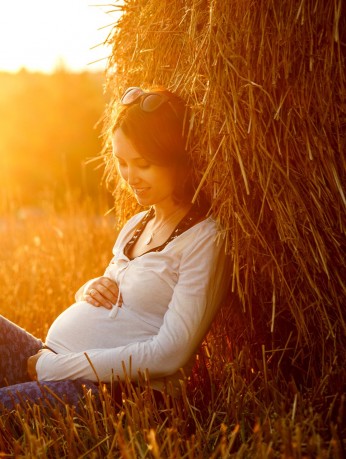 Pregnant woman holding stomach