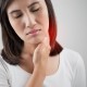 Woman holding her neck near thyroid